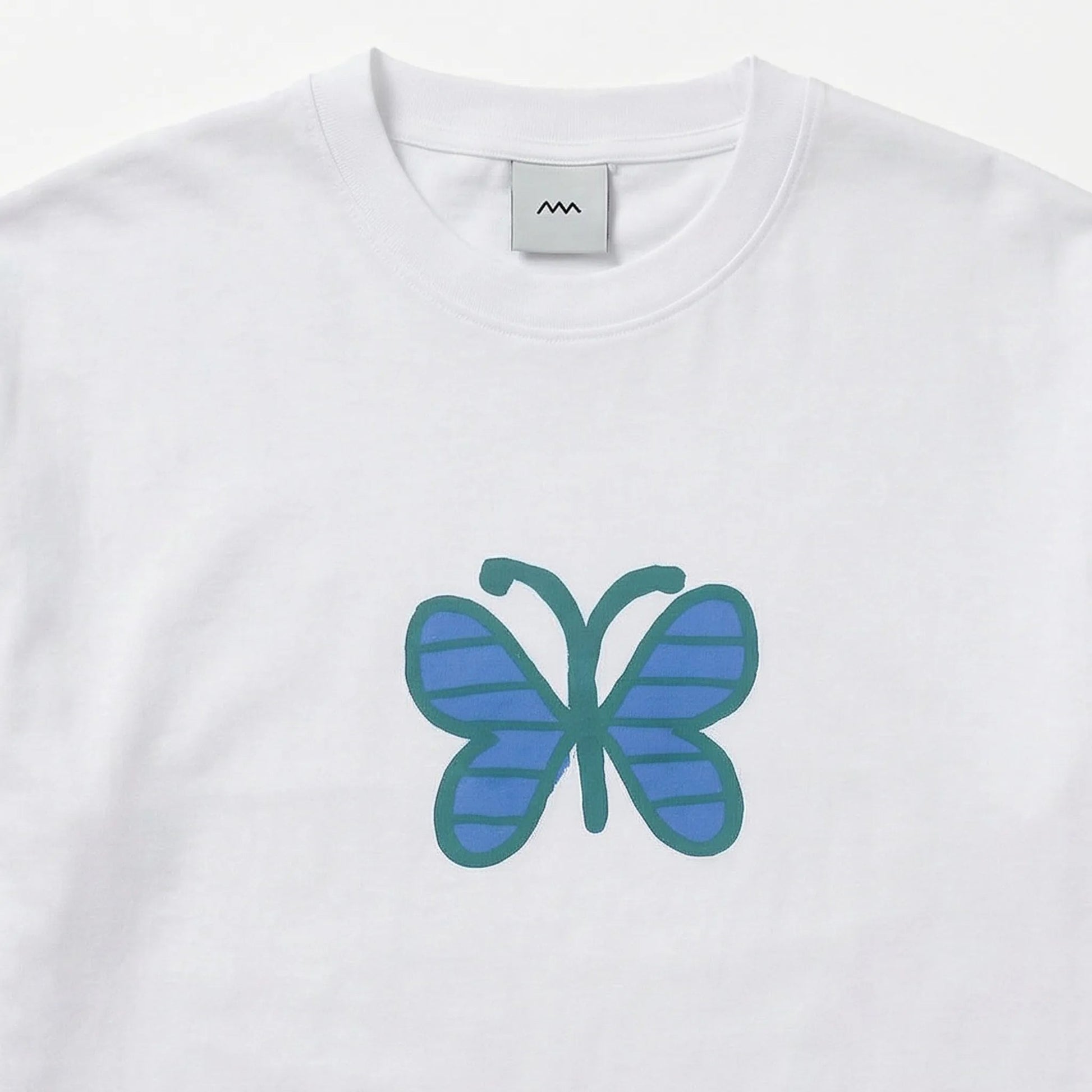 White t-shirt with a blue and green butterfly design on a white background